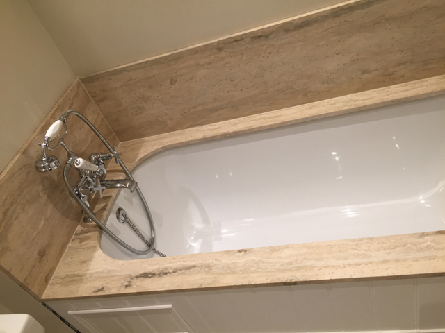 Marble bath surround with marble splashback